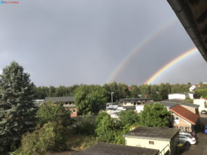 Foto mit Regenbogen und bewölkten himmel